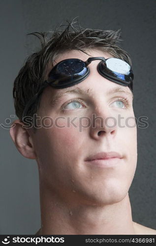 Close-up of a young man with swimming goggles