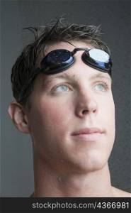 Close-up of a young man with swimming goggles
