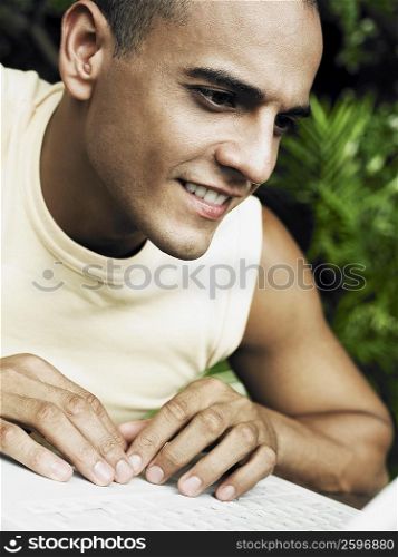Close-up of a young man working on laptop