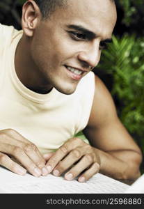 Close-up of a young man working on laptop