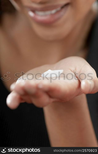 Close-up of a young woman&acute;s palm with moisturizer