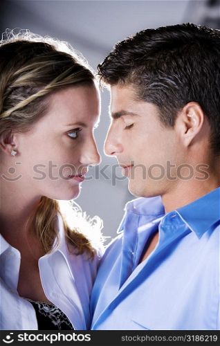 Close-up of a young woman and a mid adult man face to face