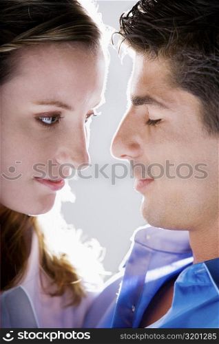 Close-up of a young woman and a mid adult man face to face
