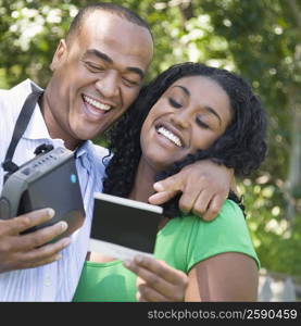 Close-up of a young woman and a mid adult man looking at a photograph