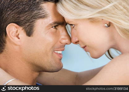 Close-up of a young woman and a mid adult man looking at each other