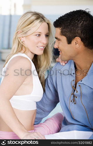 Close-up of a young woman and a mid adult man looking at each other