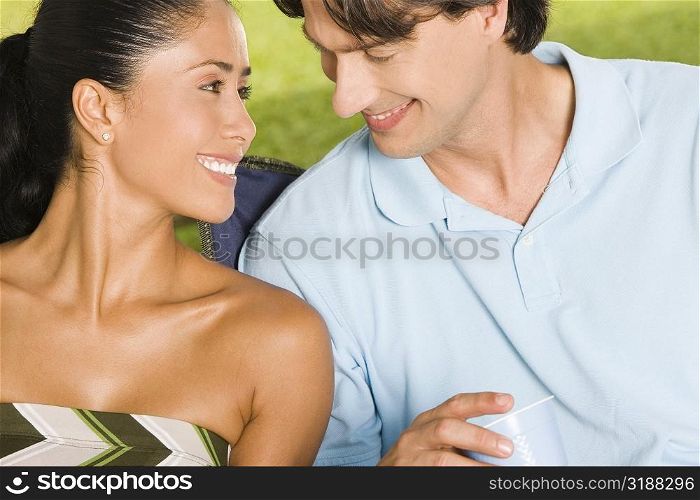 Close-up of a young woman and a mid adult man smiling