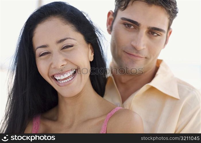 Close-up of a young woman and a mid adult man smiling