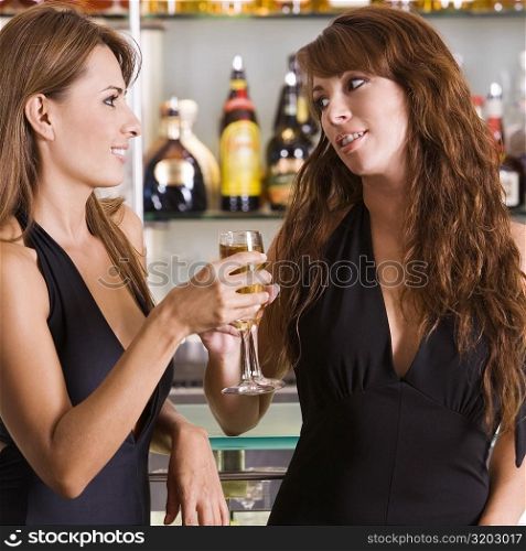 Close-up of a young woman and a mid adult woman toasting