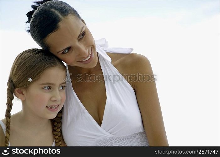 Close-up of a young woman and her daughter looking away