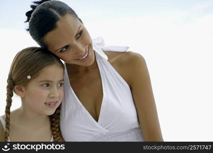 Close-up of a young woman and her daughter looking away