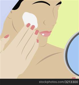 Close-up of a young woman applying moisturizer on her face