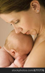 Close-up of a young woman carrying her baby