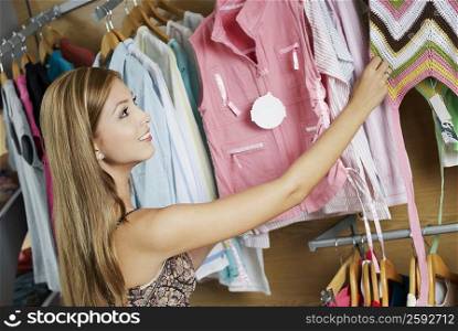 Close-up of a young woman choosing clothes in a clothing store