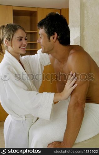 Close-up of a young woman combing a mid adult man&acute;s hair