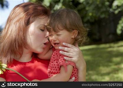 Close-up of a young woman consoling her daughter