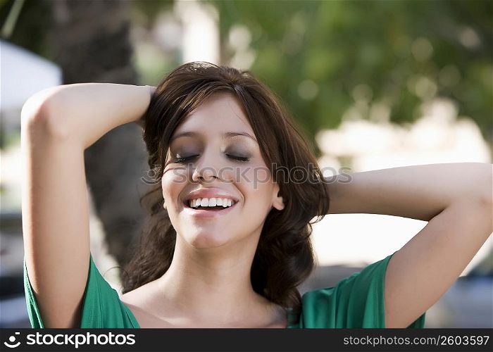 Close-up of a young woman day dreaming and smiling