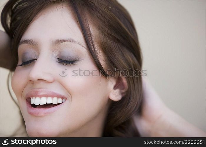 Close-up of a young woman day dreaming and smiling