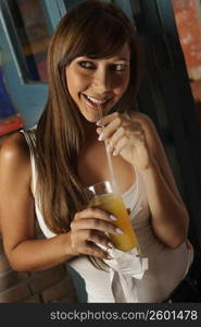 Close-up of a young woman drinking a glass of juice