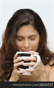 Close-up of a young woman drinking coffee
