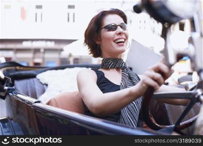 Close-up of a young woman driving a car