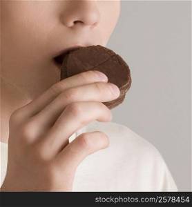 Close-up of a young woman eating a cookie