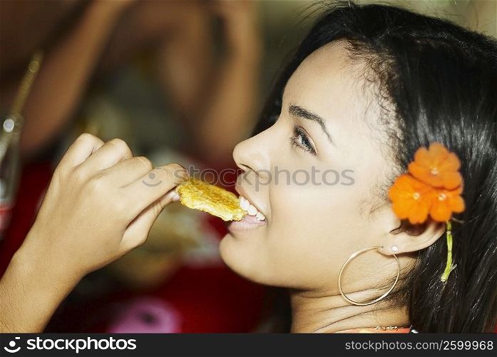 Close-up of a young woman eating a wafer