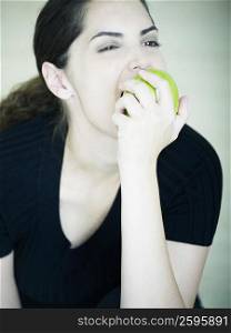 Close-up of a young woman eating an apple