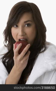 Close-up of a young woman eating an apple