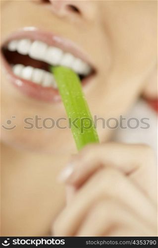 Close-up of a young woman eating an asparagus