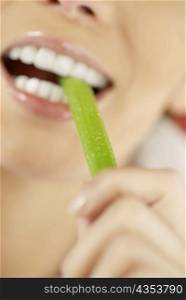 Close-up of a young woman eating an asparagus
