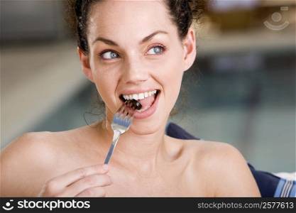 Close-up of a young woman eating an olive