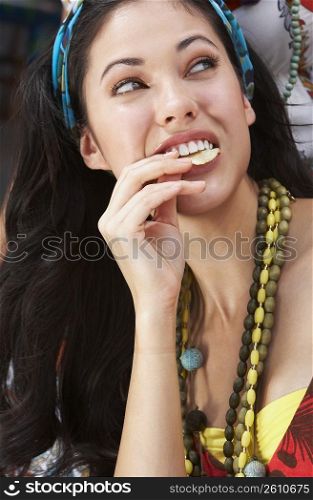 Close-up of a young woman eating potato chips