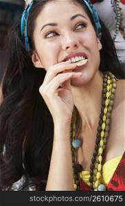 Close-up of a young woman eating potato chips