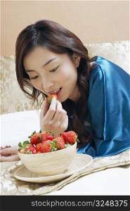 Close-up of a young woman eating strawberries