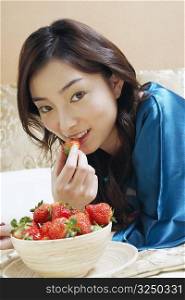 Close-up of a young woman eating strawberries
