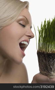 Close-up of a young woman eating wheatgrass