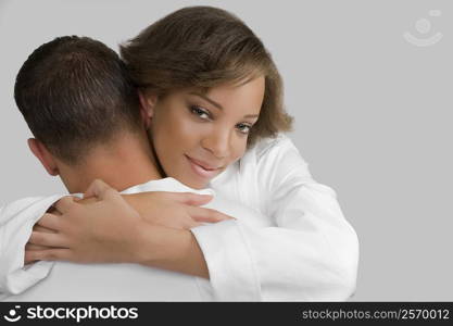 Close-up of a young woman embracing a mid adult man