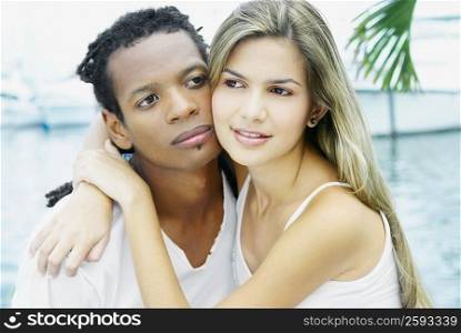 Close-up of a young woman embracing a young man