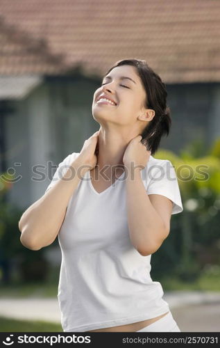 Close-up of a young woman exercising and smiling