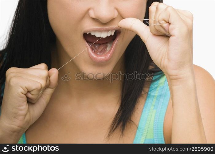 Close-up of a young woman flossing her teeth