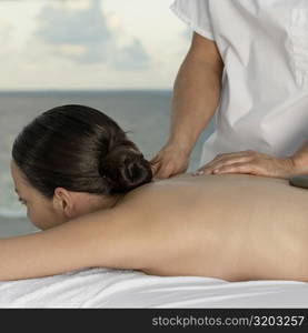 Close-up of a young woman getting a back massage