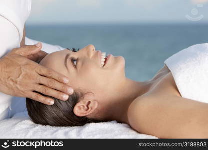 Close-up of a young woman getting a head massage