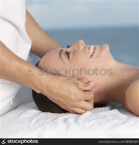 Close-up of a young woman getting a head massage