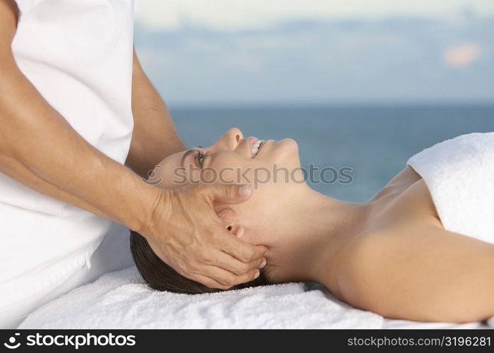 Close-up of a young woman getting a head massage