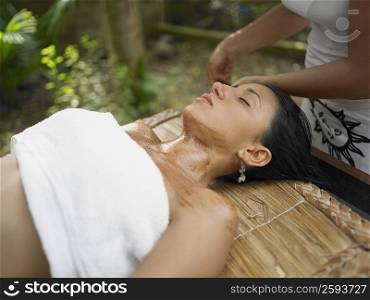Close-up of a young woman getting spa treatment