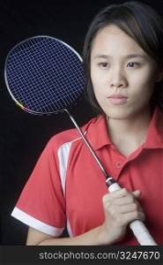 Close-up of a young woman holding a badminton racket