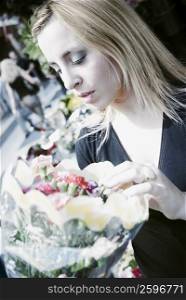 Close-up of a young woman holding a bouquet of flowers