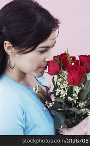 Close-up of a young woman holding a bunch of roses