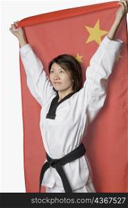 Close-up of a young woman holding a Chinese flag